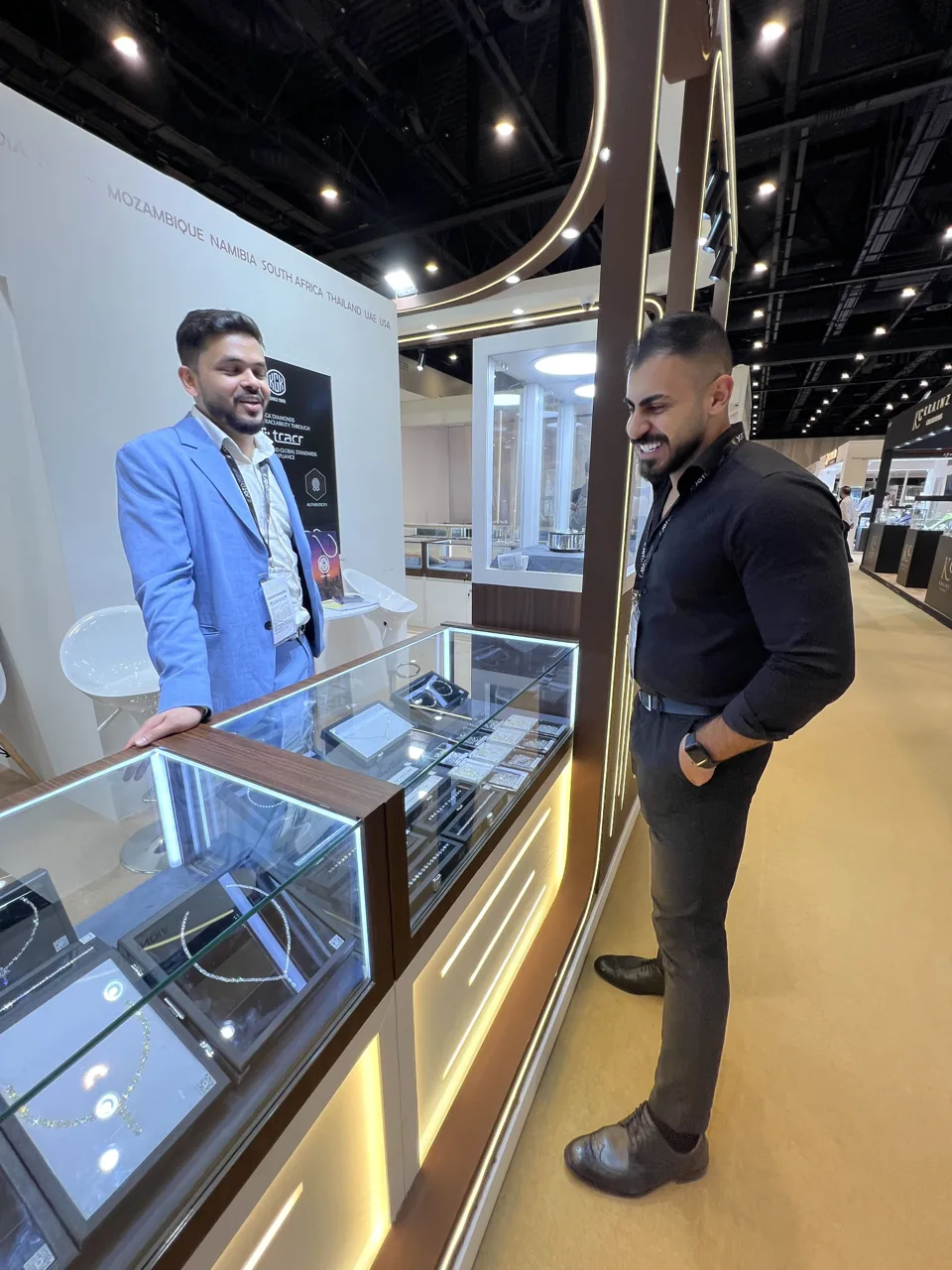Visitors speaking beside a KGK jewellery display