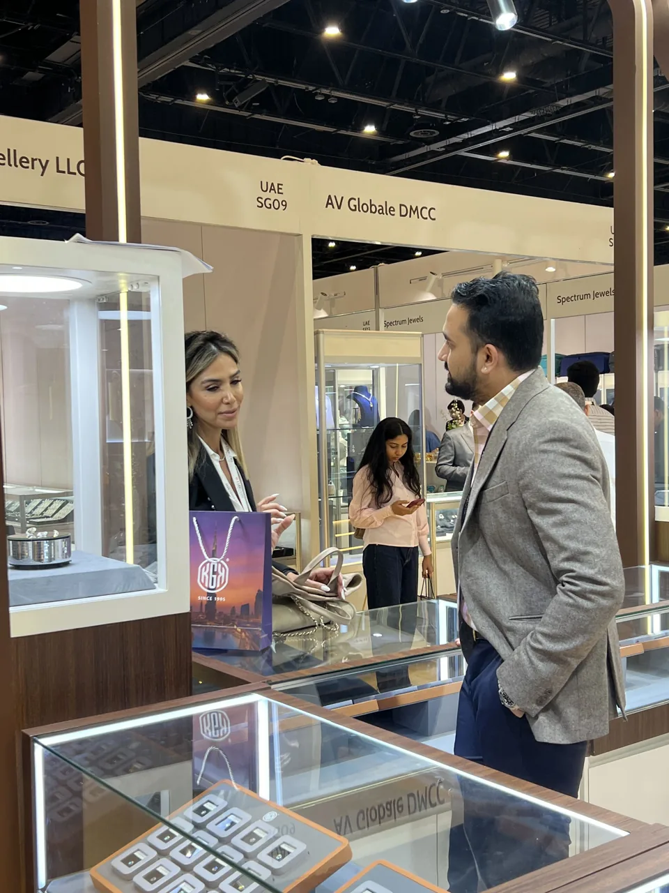 A visitor discussing jewellery at the KGK booth