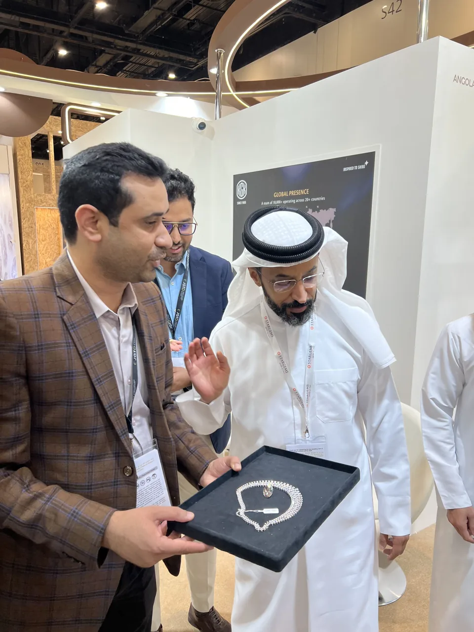 KGK team presenting a jewellery set to visitors